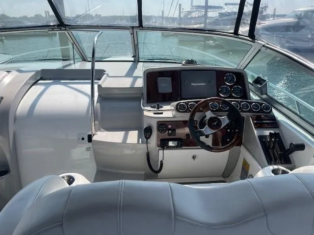  Yacht Photos Pics 2005 Formula 34PC yacht cockpit with steering wheel and navigation controls.