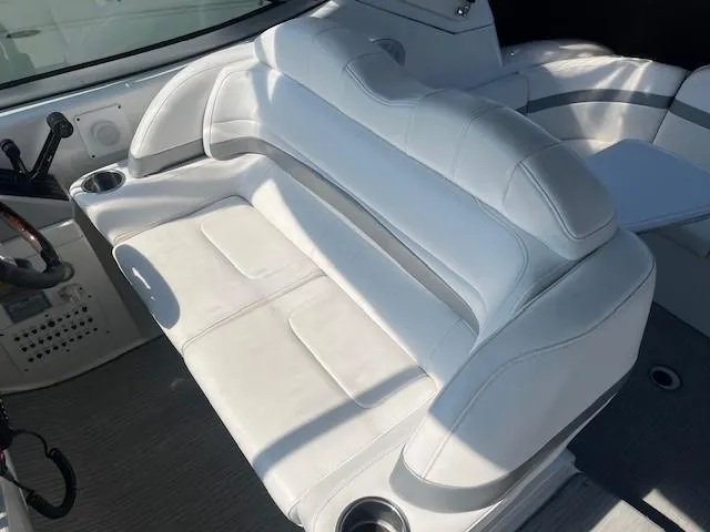  Yacht Photos Pics 2005 Formula 34PC boat interior with white leather seating and cup holders.