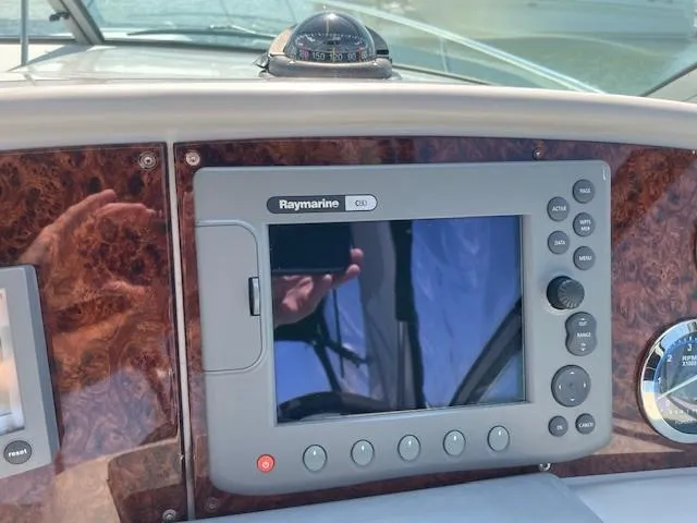  Yacht Photos Pics Raymarine GPS system on 2005 Formula 34PC boat dashboard with compass and wood paneling.
