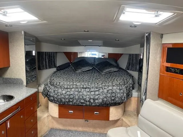  Yacht Photos Pics Interior of a 2005 Formula 34PC boat with a cozy bed and modern amenities.