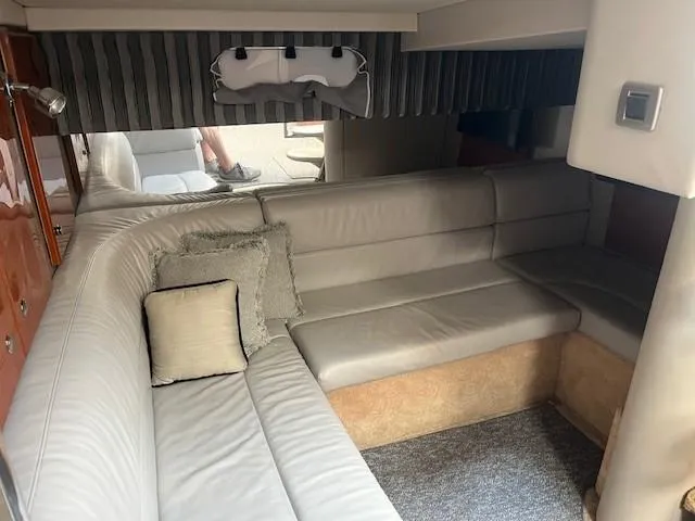  Yacht Photos Pics Interior of 2005 Formula 34PC yacht with beige leather seating and decorative pillows.