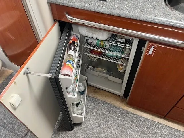  Yacht Photos Pics Mini fridge in a 2005 Formula 34PC boat galley, stocked with beverages and snacks.