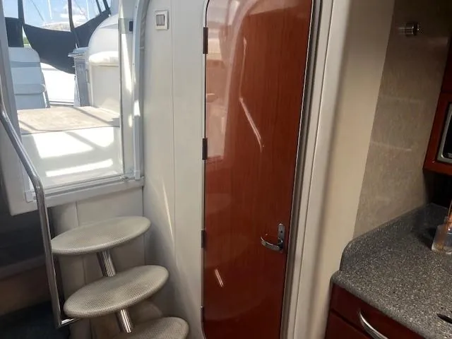  Yacht Photos Pics Interior of a 2005 Formula 34PC boat with stairs and wooden door.