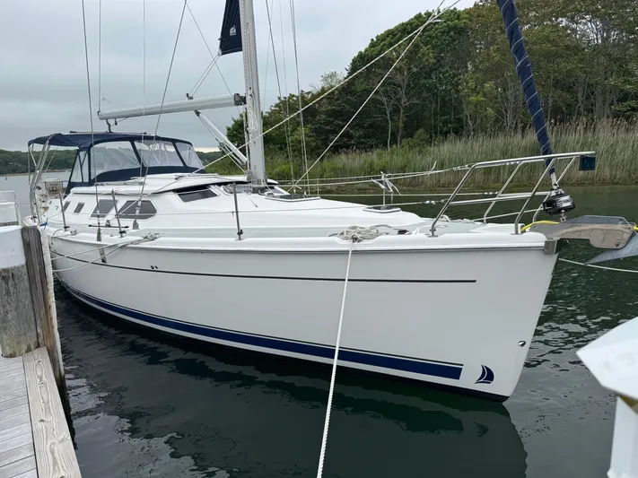 Strider Yacht Photos Pics 2006 Hunter 41 Deck Salon sailboat docked in a serene marina setting.