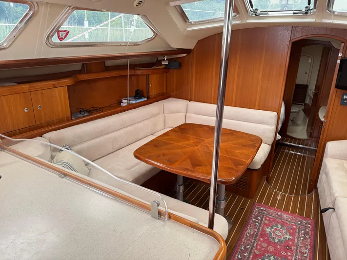 Strider Yacht Photos Pics Interior of 2006 Hunter 41 Deck Salon with wood finish and cozy seating area.