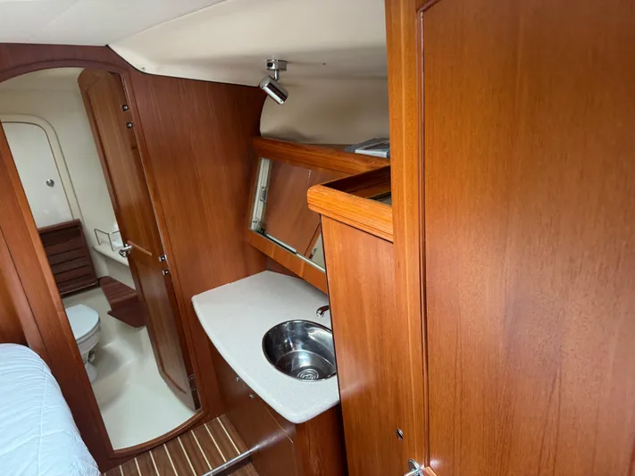 Strider Yacht Photos Pics 2006 Hunter 41 Deck Salon interior with wooden cabinetry, sink, and bathroom.
