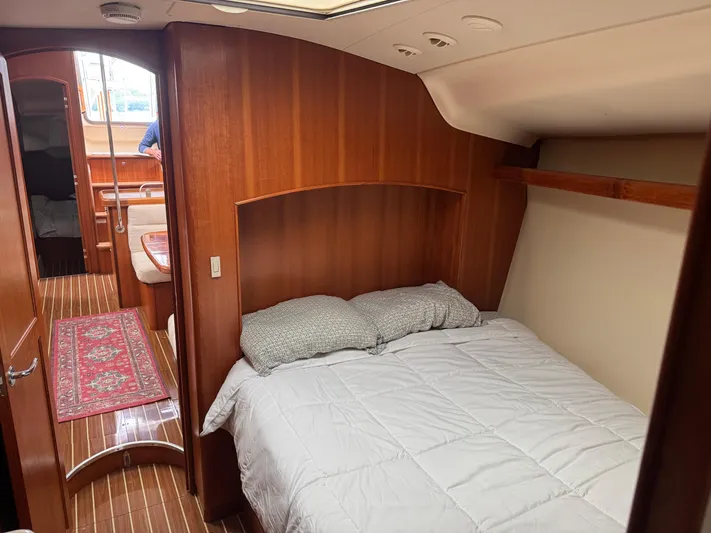 Strider Yacht Photos Pics Cozy bedroom in 2006 Hunter 41 Deck Salon yacht with wood paneling and comfortable bedding.