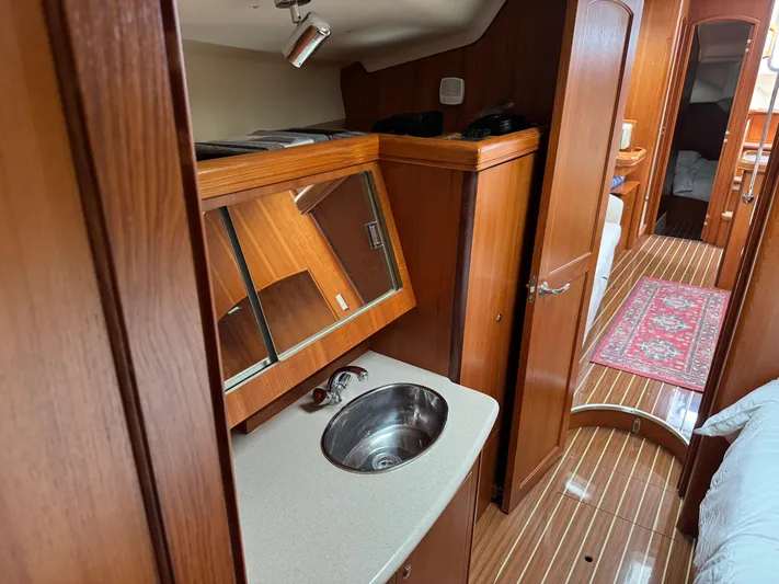 Strider Yacht Photos Pics Interior of 2006 Hunter 41 Deck Salon yacht with wood finish and compact sink.