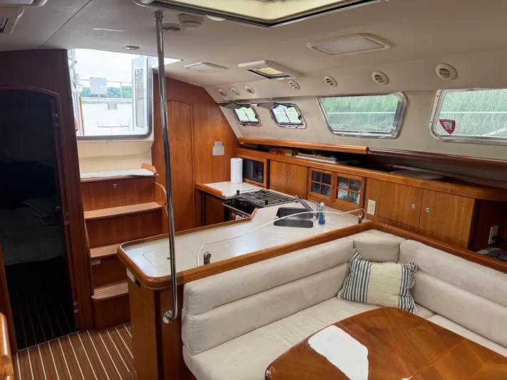 Strider Yacht Photos Pics Interior of 2006 Hunter 41 Deck Salon, featuring a cozy seating area and modern kitchen.