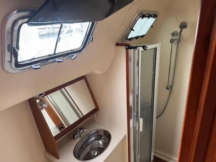 Strider Yacht Photos Pics Bathroom interior of 2006 Hunter 41 Deck Salon yacht with shower and sink.