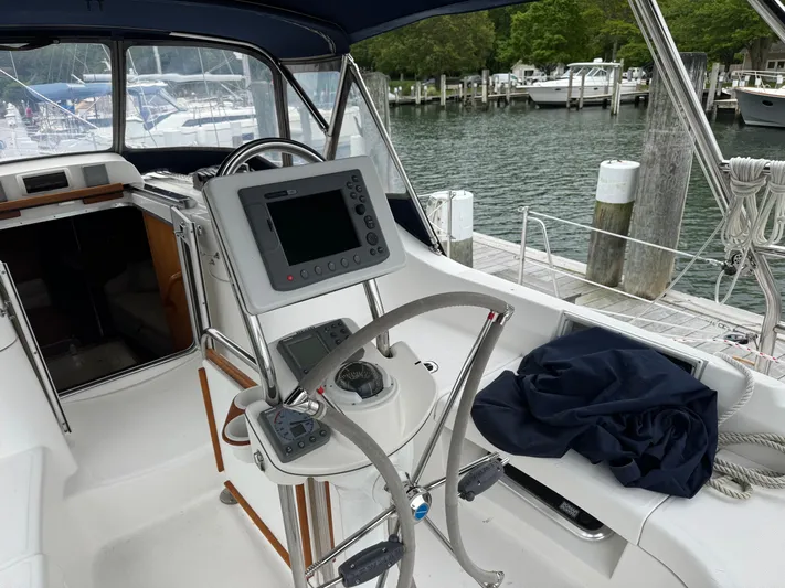 Strider Yacht Photos Pics Cockpit of 2006 Hunter 41 Deck Salon sailboat with navigation equipment and marina view.