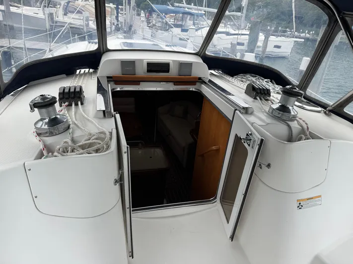 Strider Yacht Photos Pics 2006 Hunter 41 Deck Salon yacht interior with open cabin doors and visible winches.