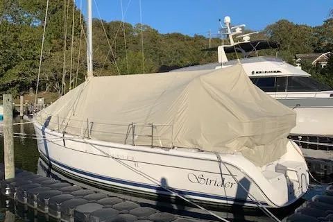 Strider Yacht Photos Pics 2006 Hunter 41 Deck Salon sailboat covered at dock, named "Strider."