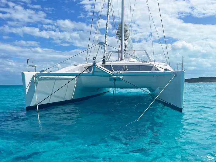 Skye Yacht Photos Pics 2023 Mystique Yachts Silhouette 800 catamaran on clear blue water under a sunny sky.