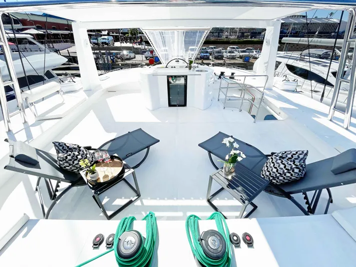 Skye Yacht Photos Pics Luxurious 2023 Mystique Yachts Silhouette 800 deck with lounge chairs and modern amenities.
