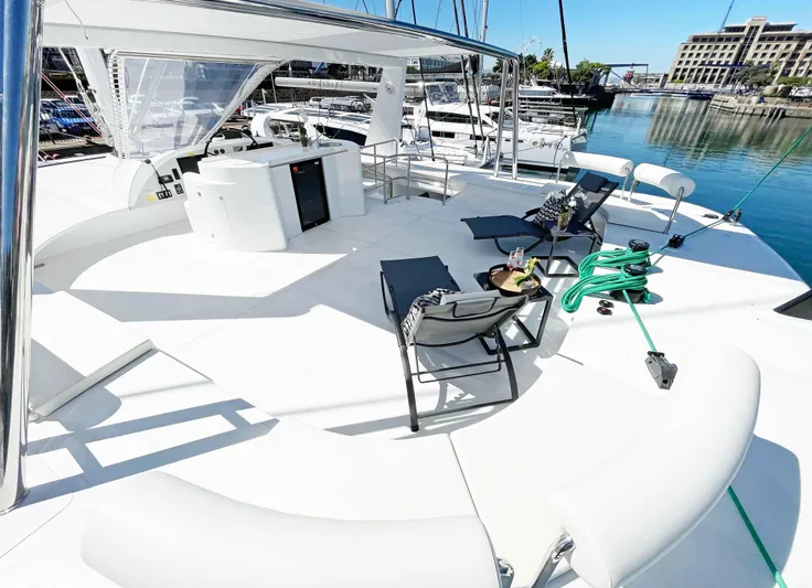 Skye Yacht Photos Pics Luxurious 2023 Mystique Yachts Silhouette 800 deck with lounge chairs and marina view.