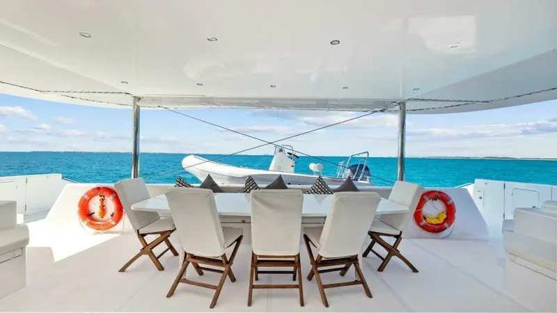 Skye Yacht Photos Pics Luxurious 2023 Mystique Yachts Silhouette 800 deck with ocean view and elegant seating.