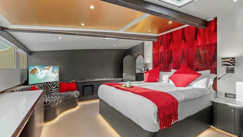 Skye Yacht Photos Pics Luxurious bedroom in 2023 Mystique Yachts Silhouette 800 with modern decor and vibrant red accents.