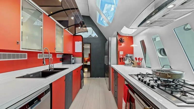 Skye Yacht Photos Pics Modern kitchen interior on 2023 Mystique Yachts Silhouette 800, featuring sleek design and vibrant colors.