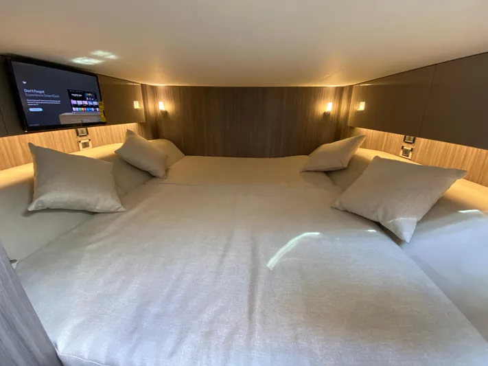 Aquaholic Yacht Photos Pics Luxurious cabin interior of 2023 Sea Ray SLX 400 with cozy bedding and ambient lighting.