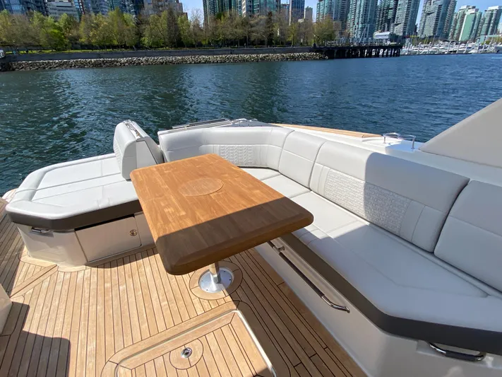 Aquaholic Yacht Photos Pics 2023 Sea Ray SLX 400 yacht with elegant seating and wooden table on deck.