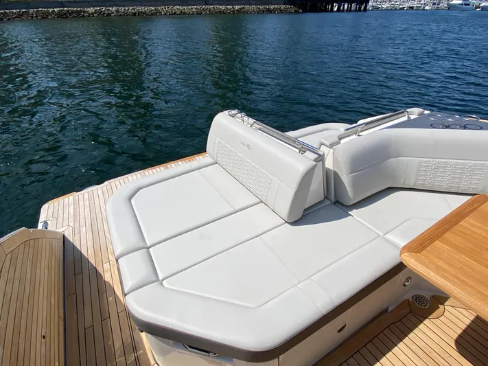 Aquaholic Yacht Photos Pics Luxurious seating on 2023 Sea Ray SLX 400 yacht, docked by serene waters.