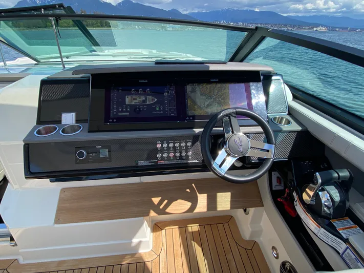 Aquaholic Yacht Photos Pics 2023 Sea Ray SLX 400 helm with modern controls, steering wheel, and scenic ocean view.