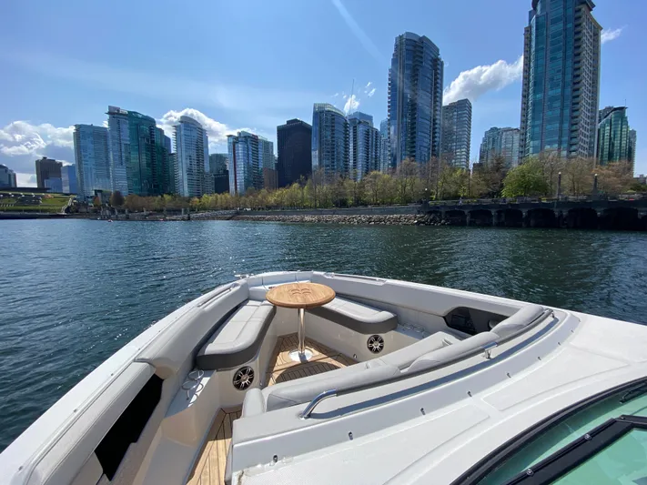Aquaholic Yacht Photos Pics 2023 Sea Ray SLX 400 boat with city skyline in the background.