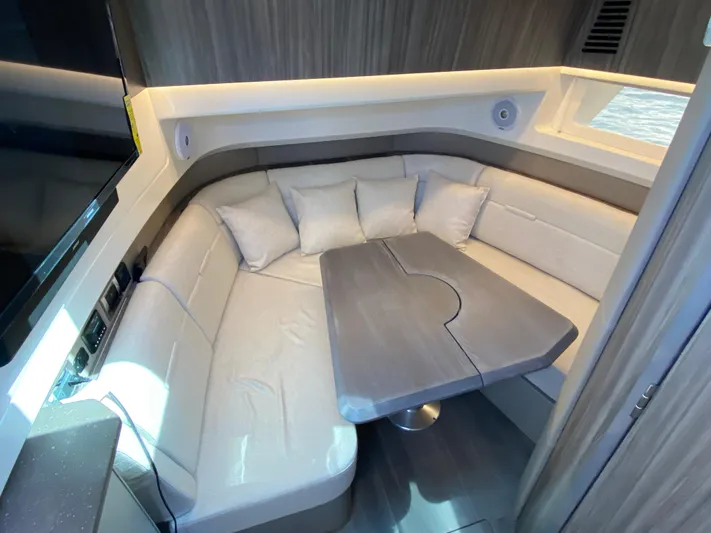 Aquaholic Yacht Photos Pics 2023 Sea Ray SLX 400 interior with plush seating and modern table.