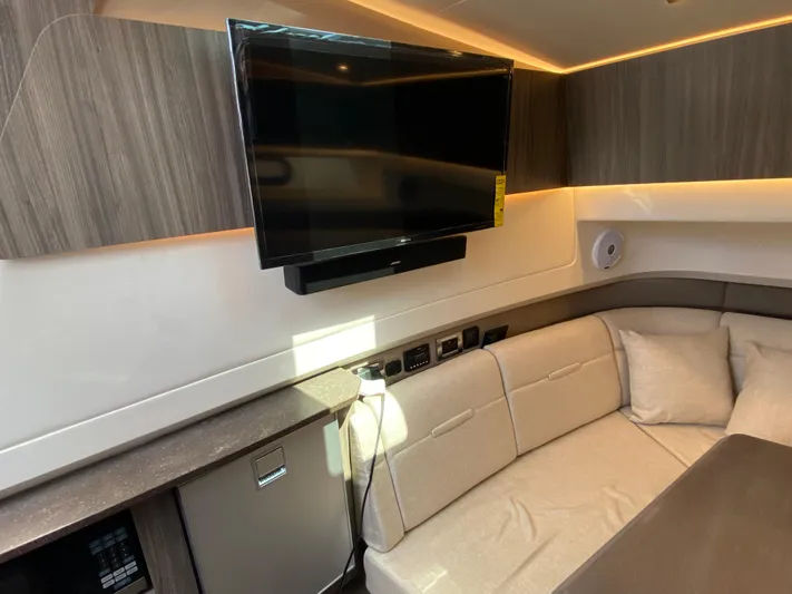 Aquaholic Yacht Photos Pics Interior of 2023 Sea Ray SLX 400 with TV, sofa, and modern cabinetry.