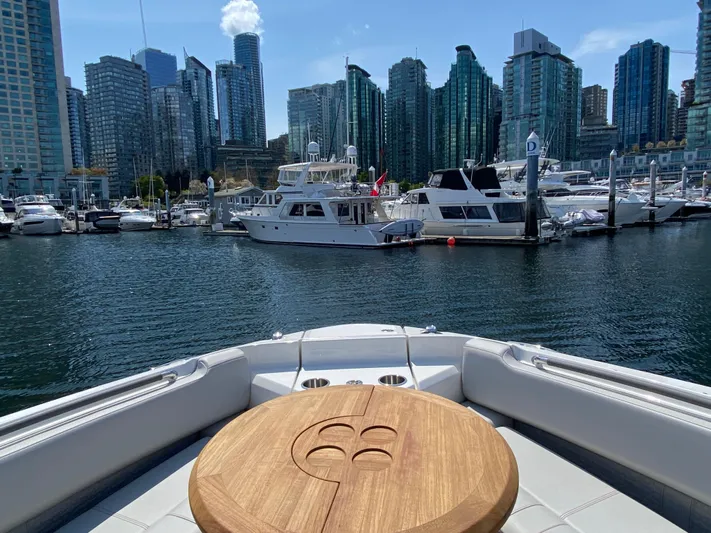 Aquaholic Yacht Photos Pics 2023 Sea Ray SLX 400 yacht in urban marina with city skyline backdrop.