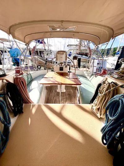 Makasi Yacht Photos Pics 2008 Tartan 4100 sailboat cockpit with ropes and wooden table, docked at marina.