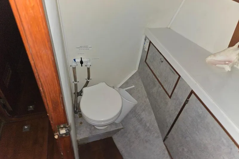 Cookie Monster Too Yacht Photos Pics 1982 Tayana Center Cockpit Cutter Ketch bathroom with toilet and storage cabinets.