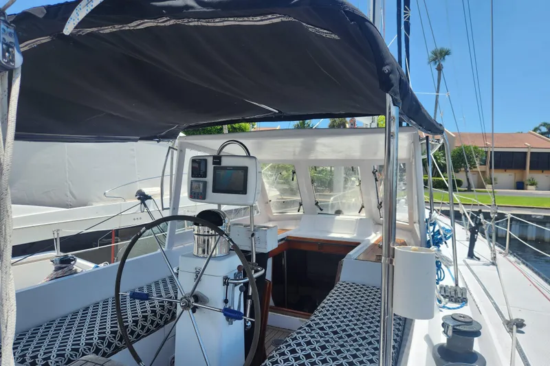 Cookie Monster Too Yacht Photos Pics 1982 Tayana Center Cockpit Cutter Ketch with steering wheel and navigation equipment.