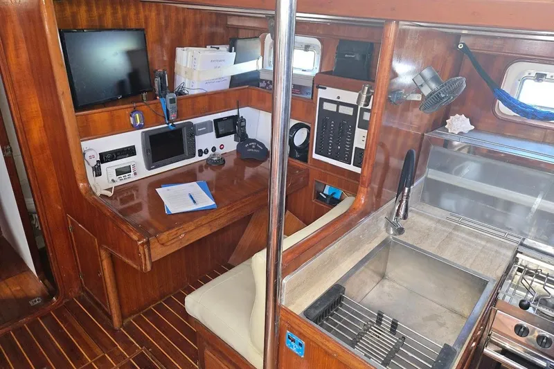 Cookie Monster Too Yacht Photos Pics Interior of 1982 Tayana Center Cockpit Cutter Ketch with navigation station and galley.