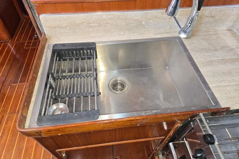 Cookie Monster Too Yacht Photos Pics Stainless steel sink in 1982 Tayana Center Cockpit Cutter Ketch yacht kitchen.