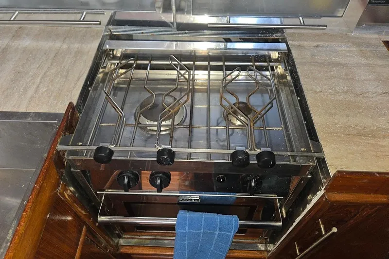 Cookie Monster Too Yacht Photos Pics Stainless steel stove in 1982 Tayana Center Cockpit Cutter Ketch yacht kitchen.