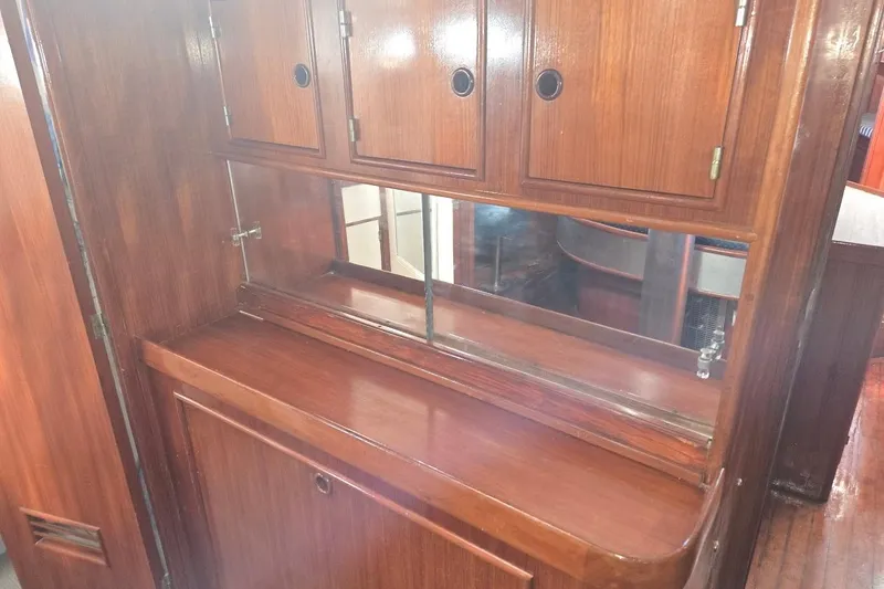 Cookie Monster Too Yacht Photos Pics Wooden interior of 1982 Tayana Center Cockpit Cutter Ketch, featuring cabinets and mirror.