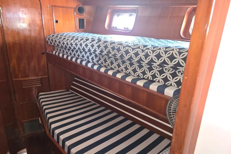 Cookie Monster Too Yacht Photos Pics 1982 Tayana Center Cockpit Cutter Ketch cabin with striped and patterned bunk beds.