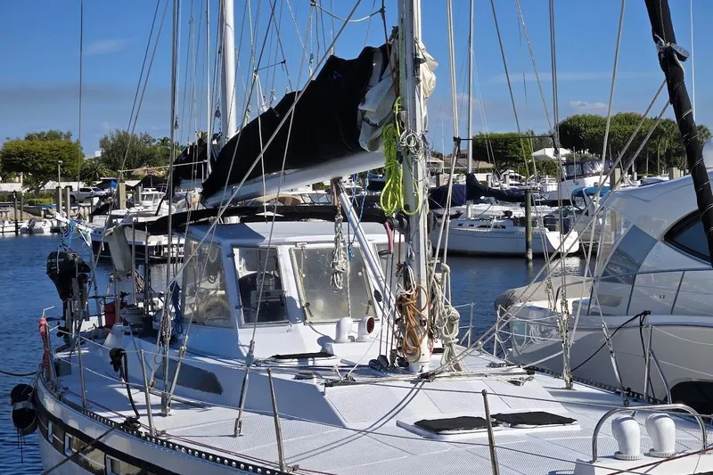 Cookie Monster Too Yacht Photos Pics 1982 Tayana Center Cockpit Cutter Ketch docked in a marina, surrounded by other boats.