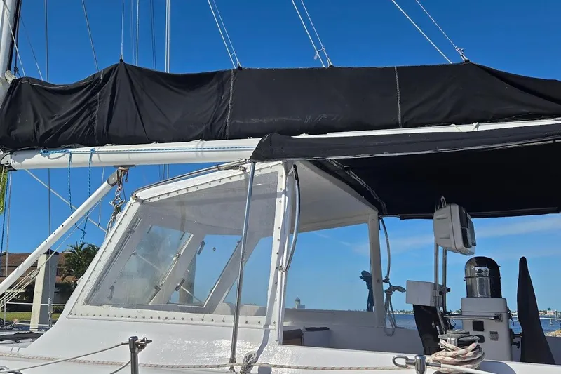 Cookie Monster Too Yacht Photos Pics 1982 Tayana Center Cockpit Cutter Ketch with black sail cover and clear cockpit enclosure.