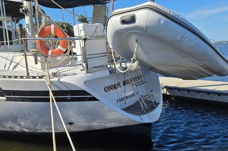 Cookie Monster Too Yacht Photos Pics 1982 Tayana Center Cockpit Cutter Ketch docked with dinghy and lifebuoy, Fort Myers.