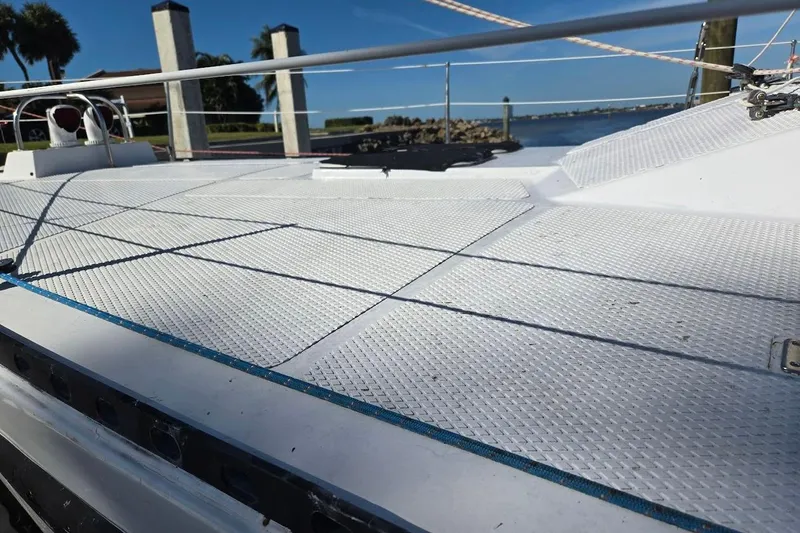 Cookie Monster Too Yacht Photos Pics 1982 Tayana Center Cockpit Cutter Ketch deck with textured surface, docked by the water.
