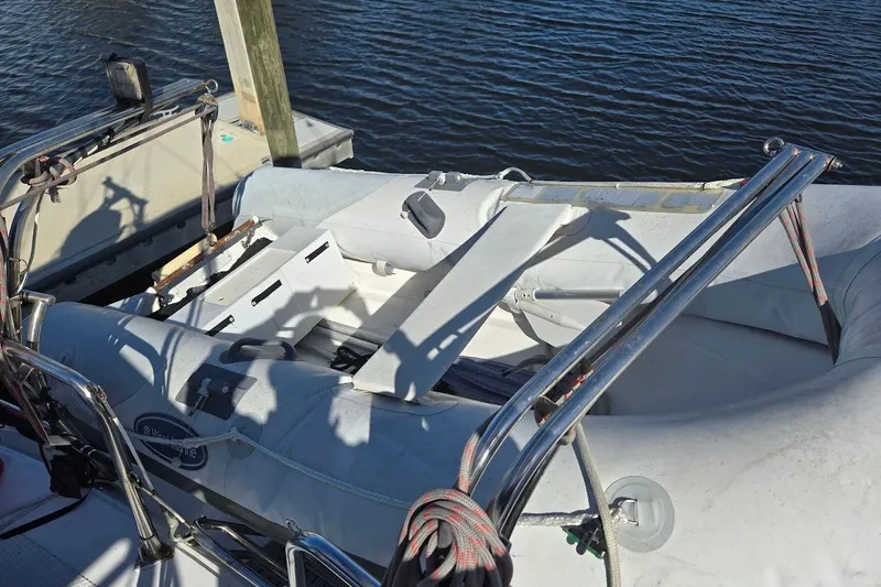 Cookie Monster Too Yacht Photos Pics 1982 Tayana Center Cockpit Cutter Ketch with inflatable dinghy on deck by the water.