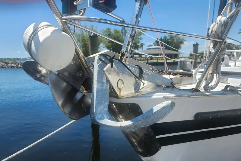 Cookie Monster Too Yacht Photos Pics 1982 Tayana Center Cockpit Cutter Ketch with anchor and propeller, docked by calm waters.