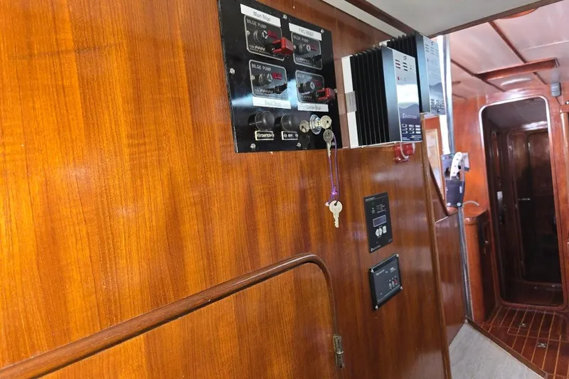 Cookie Monster Too Yacht Photos Pics 1982 Tayana Center Cockpit Cutter Ketch interior with wooden paneling and control panels.