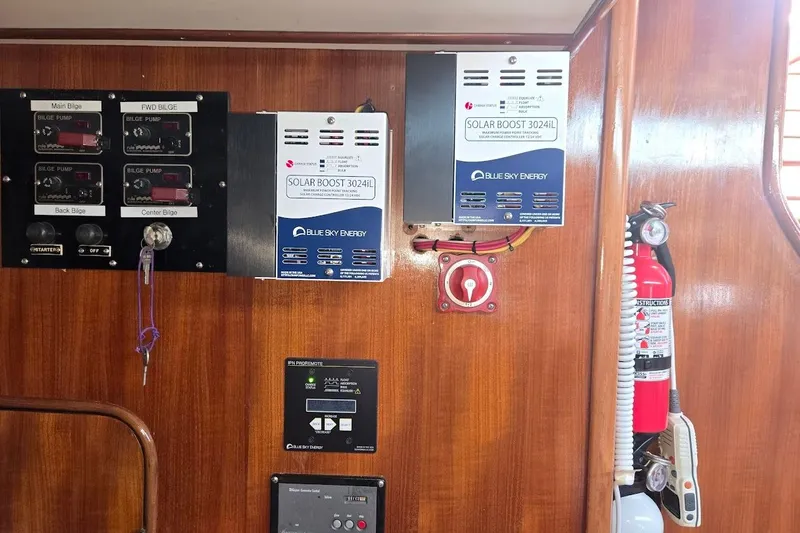 Cookie Monster Too Yacht Photos Pics Control panel and solar charger in 1982 Tayana Center Cockpit Cutter Ketch interior.