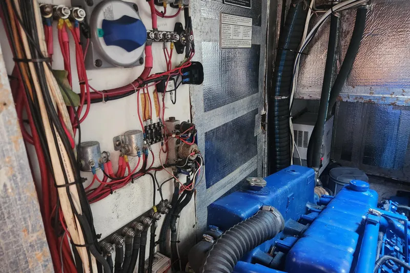 Cookie Monster Too Yacht Photos Pics Engine room of 1982 Tayana Center Cockpit Cutter Ketch with wiring and blue engine components.
