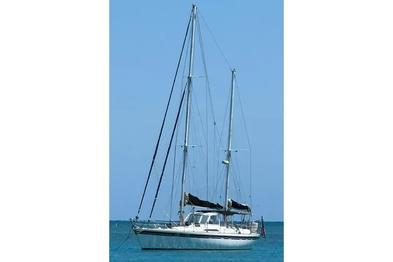 Cookie Monster Too Yacht Photos Pics 1982 Tayana Center Cockpit Cutter Ketch sailing on calm blue waters.