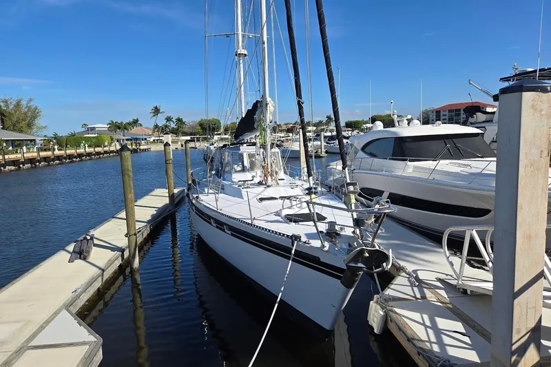 Cookie Monster Too Yacht Photos Pics 1982 Tayana Center Cockpit Cutter Ketch docked at a marina under clear blue skies.